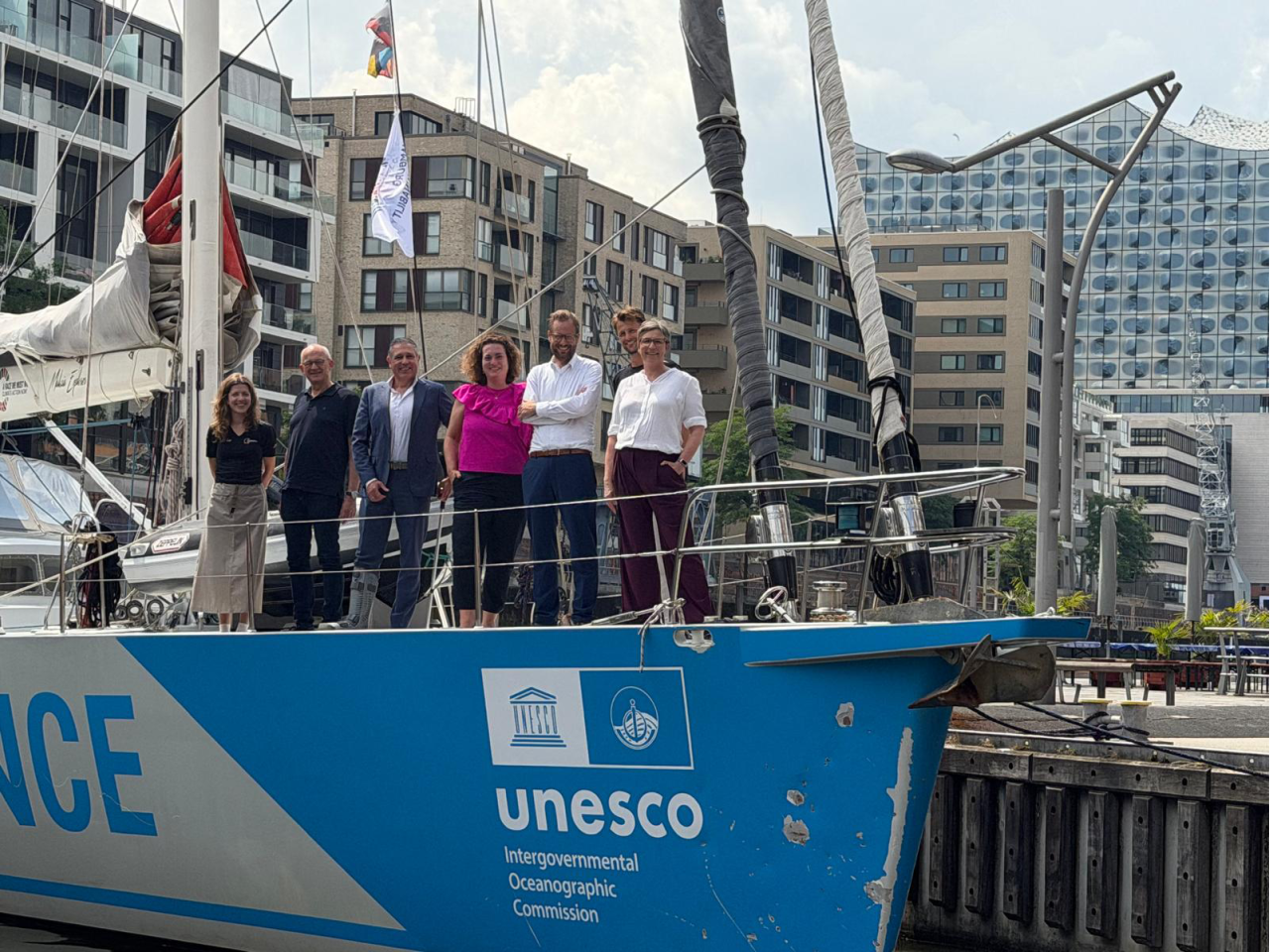 People standing on bow of ship