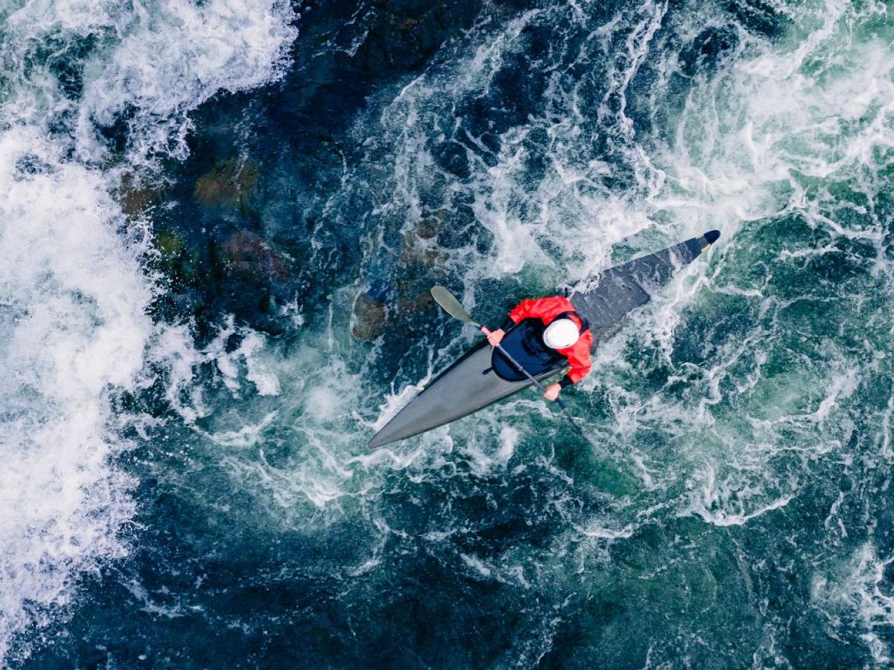 Kayak shown in rough waters.