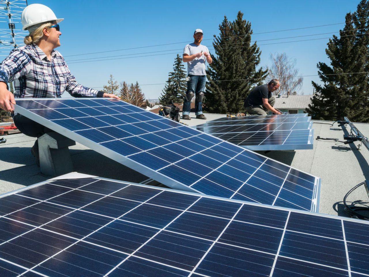  workers installing solar panels