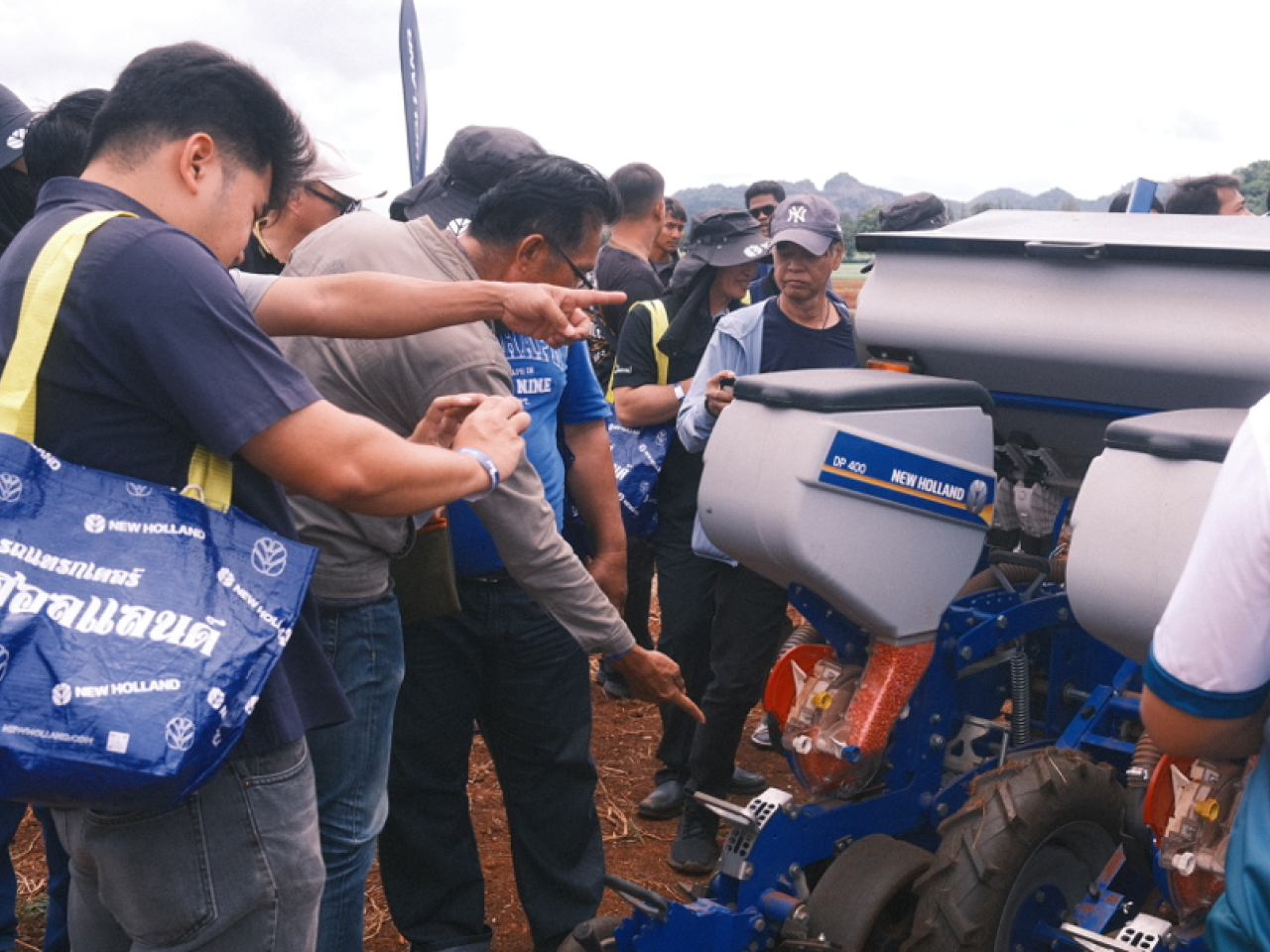 Event attendees checking out farm equipment