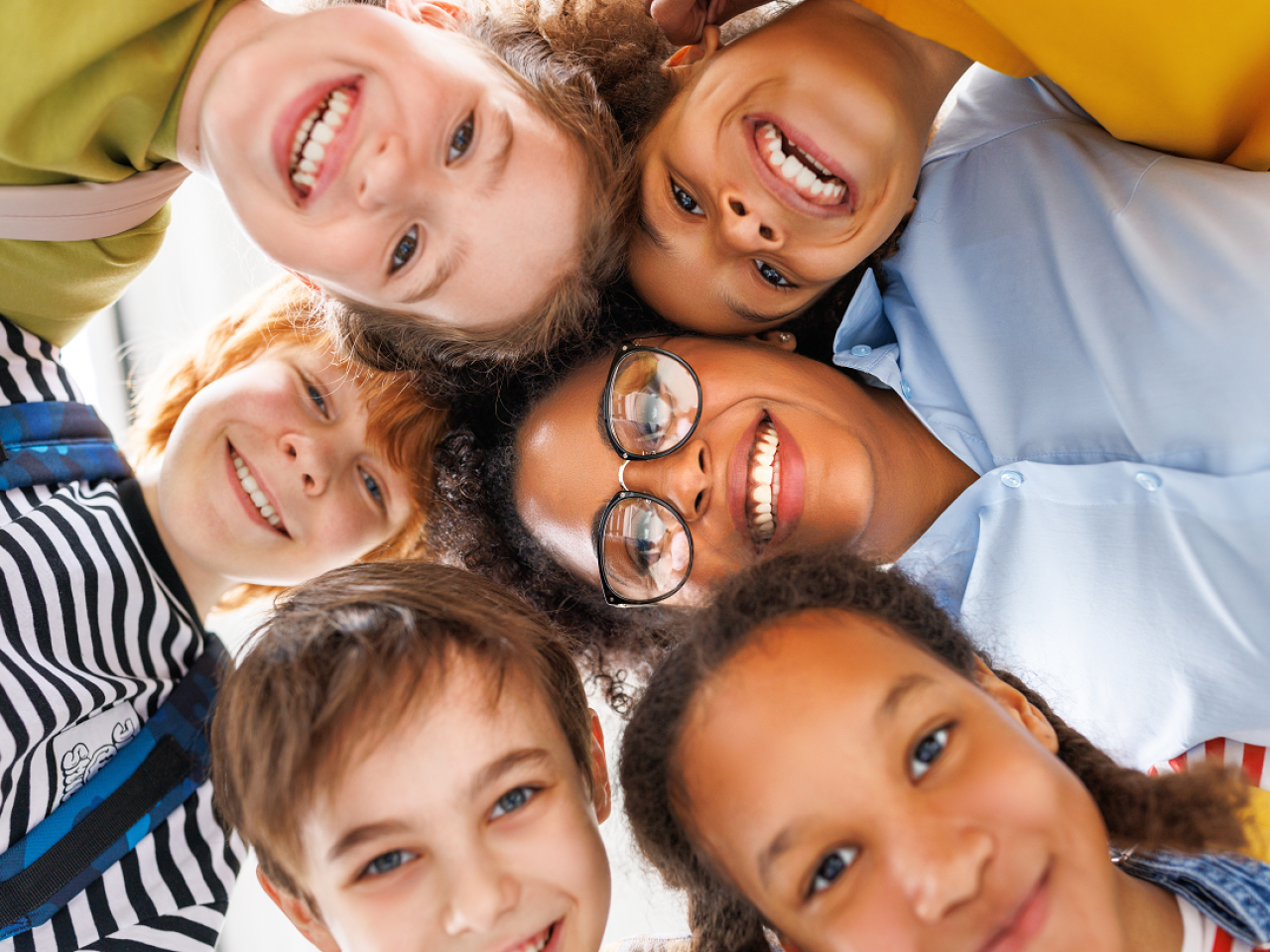 Children gathered together and smiling at the camera