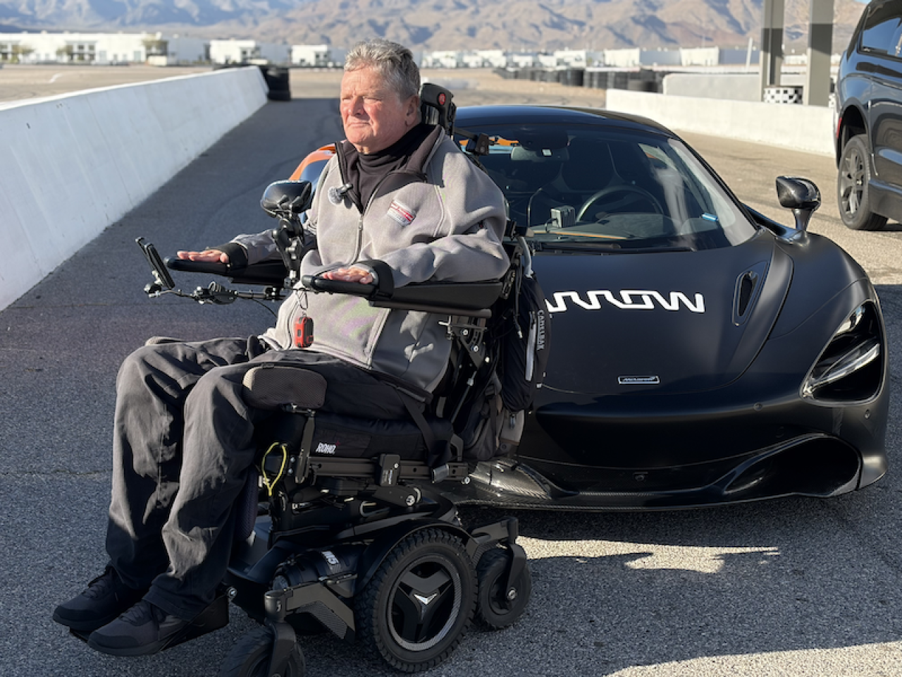Sam seated outside the Arrow SAM car
