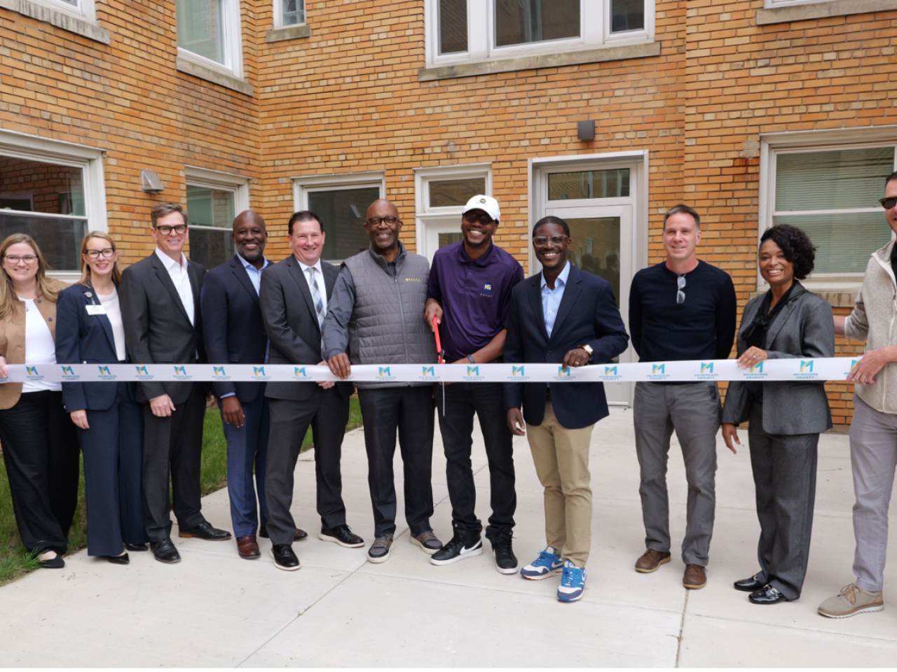 Ribbon cutting ceremony outside a building