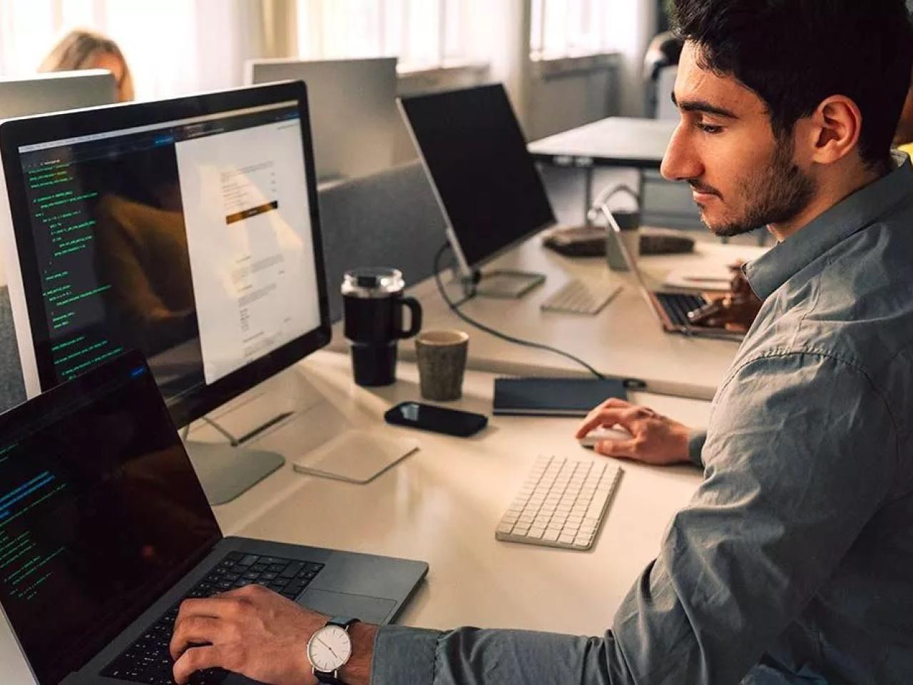 person coding at a computer