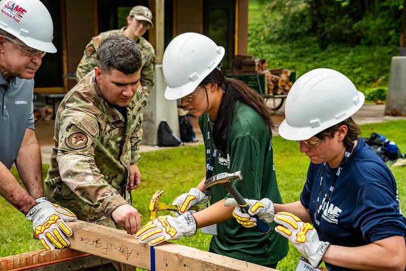 Instructor showing students how to build a structure 