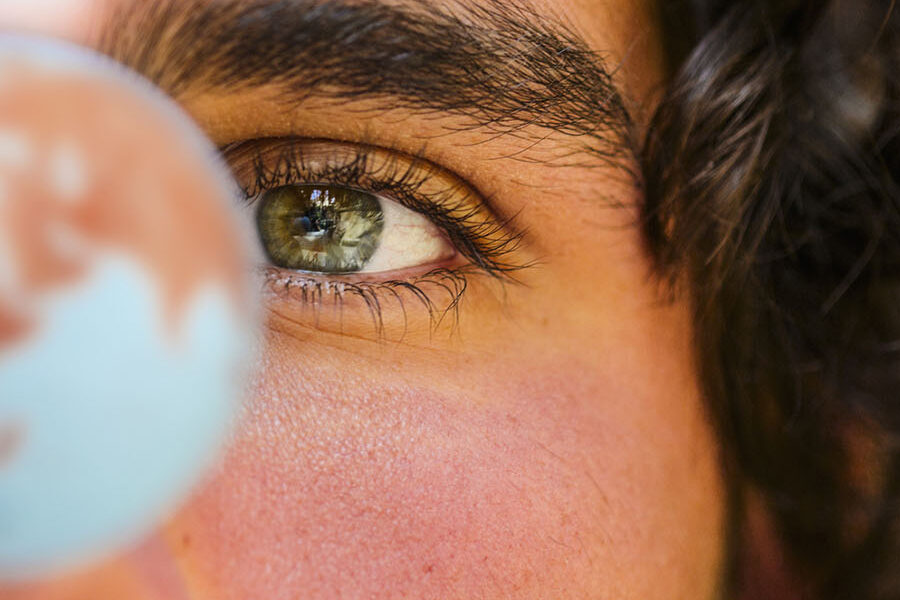 person looking at a globe