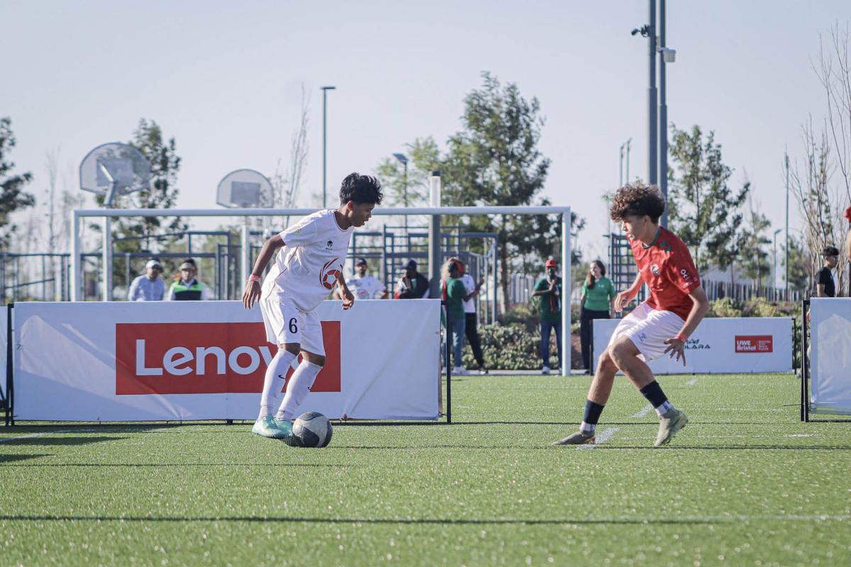 2 young people playing soccer