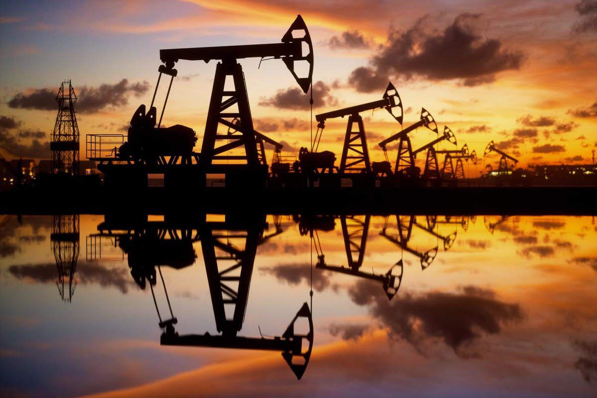 Oil wells with a sunset in the background