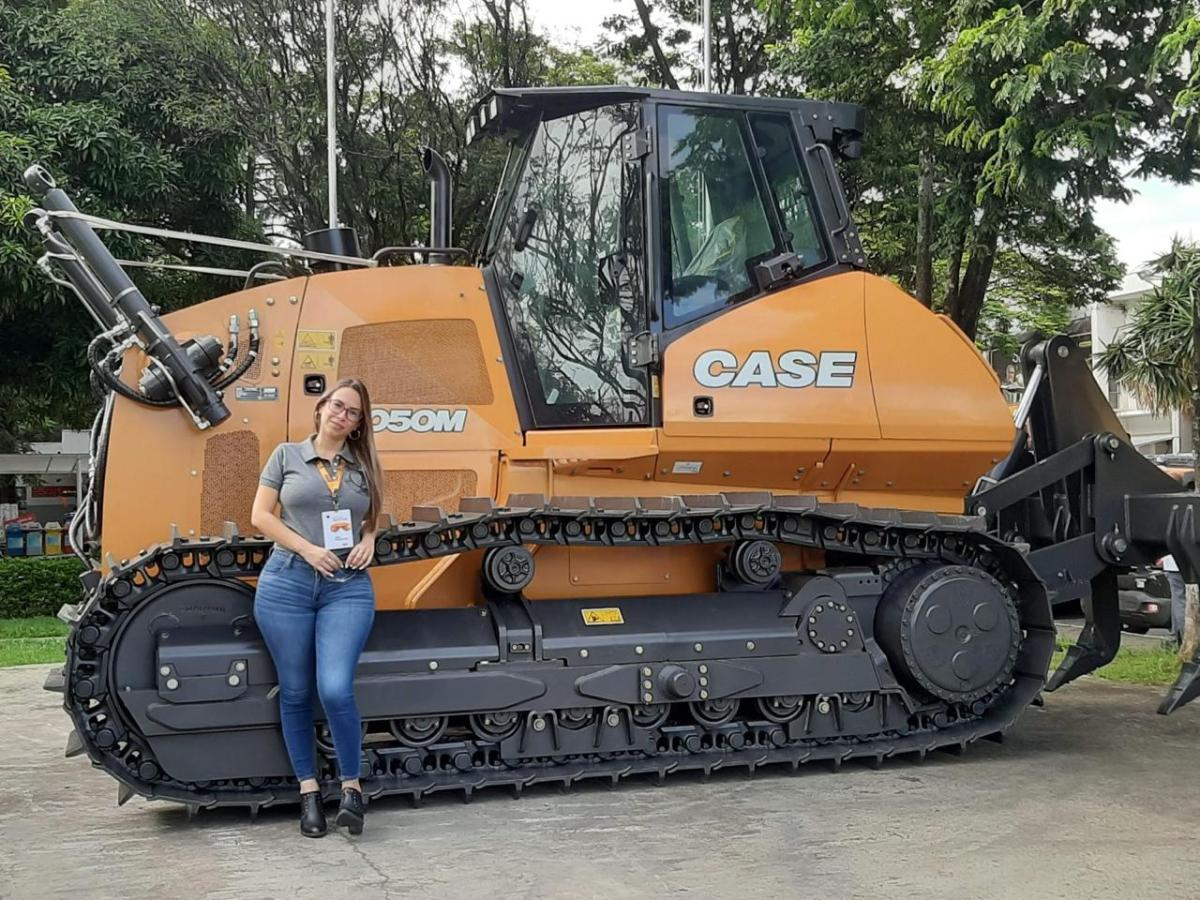 A person leaning against agricultural machinery 