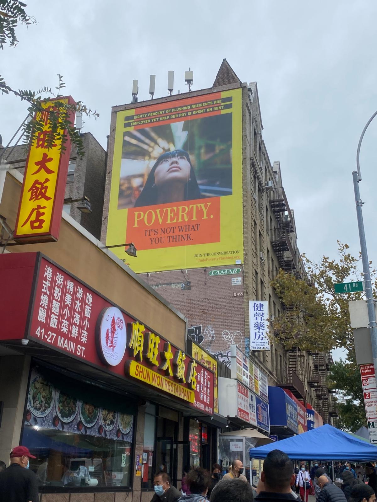 Building with a billboard that reads: Poverty. It's not what you think.