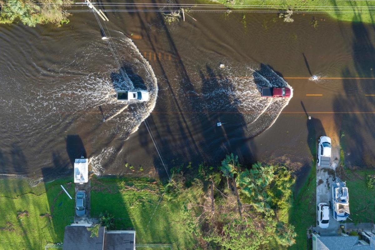 Aerial view of cars driving through a flooded street