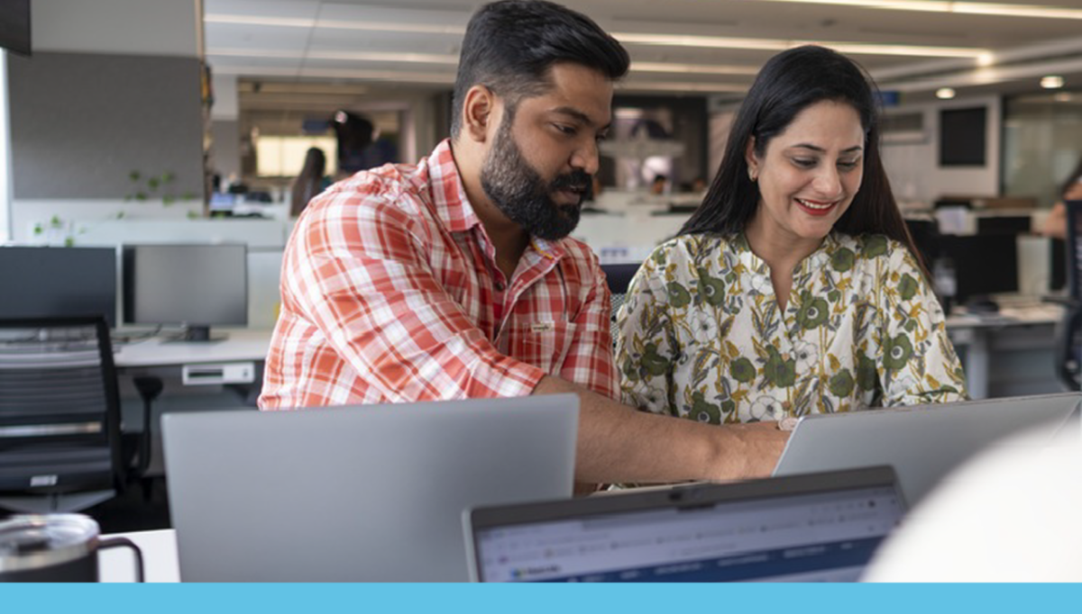Two people looking at a computer together