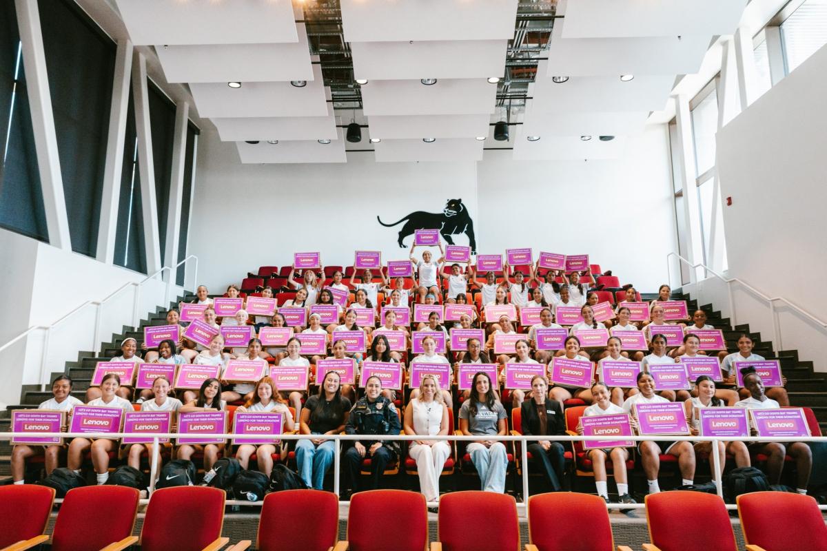 Group photo of camp participants holding boxes from Lenovo