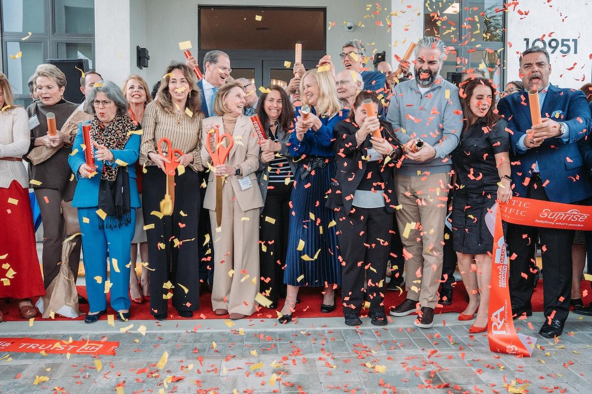 group photo behind ribbon