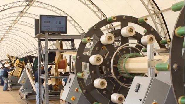 Workers produce the company's innovative liner product at a Smartpipe mobile factory.