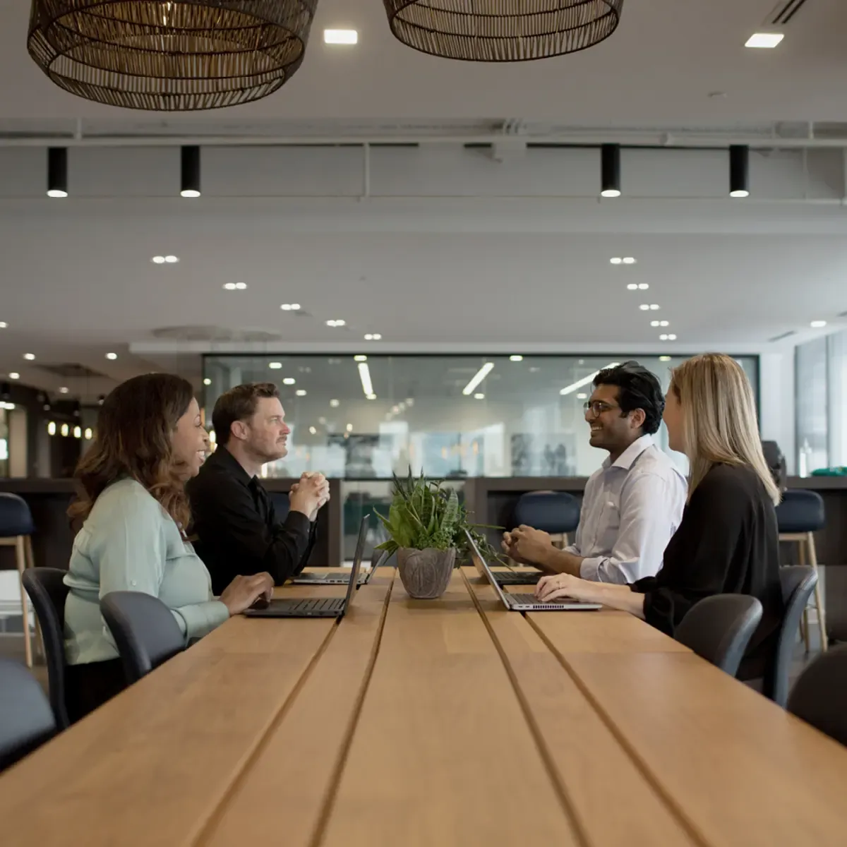 People sitting together and smiling at a conference table