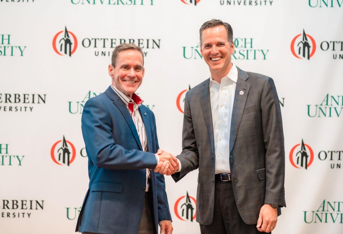 William R. Groves, J.D., chancellor of Antioch University, and John Comerford, Ph.D., president of Otterbein University, shake hands after the historic announcement of their institutions' intention to affiliate with each other to create a unique, national, nonprofit university system focused on educating students both for careers and to prepare students to advance social justice, democracy, and the common good.