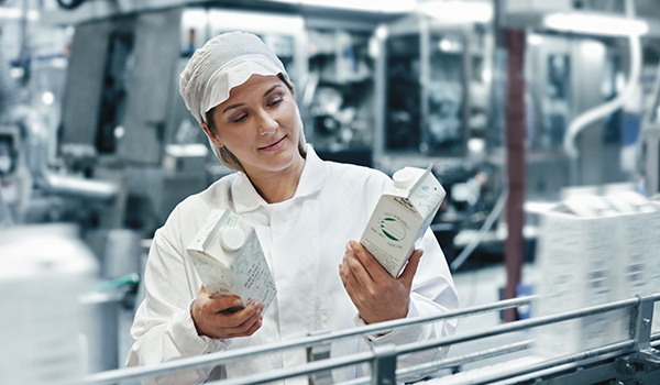 woman looking at milk container