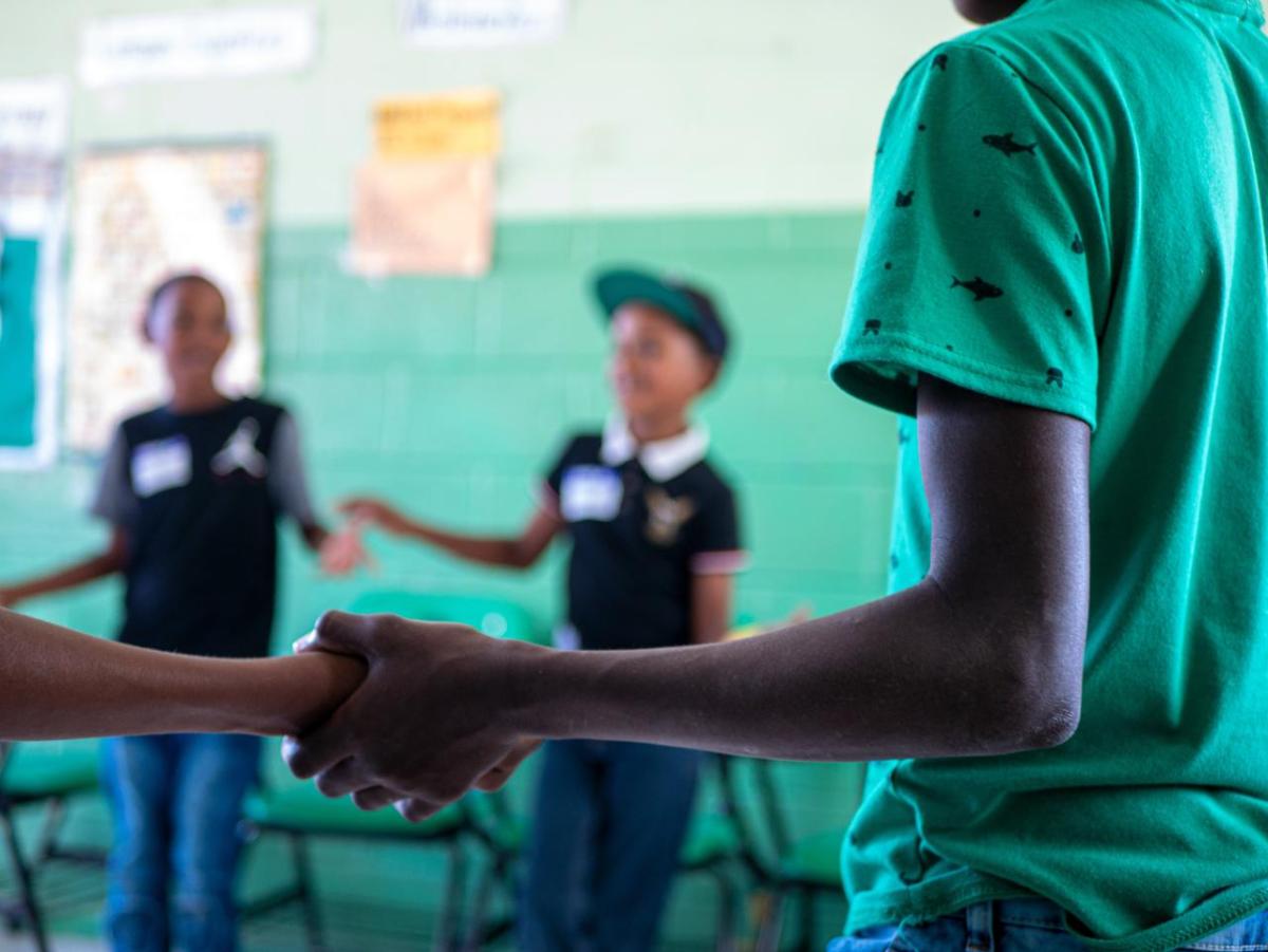 students holding hands in a circle
