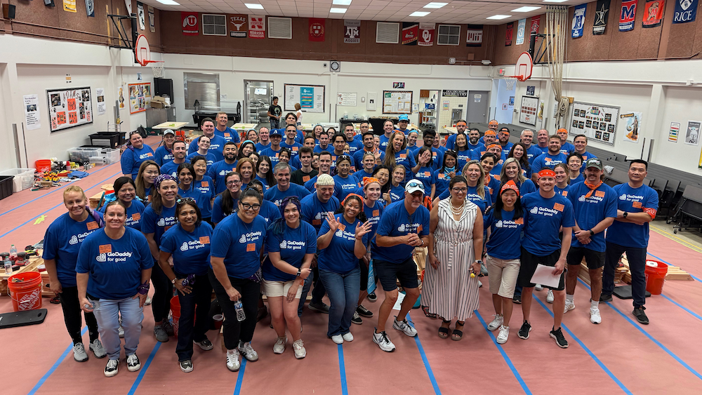 Group photo of GoDaddy volunteers in gym