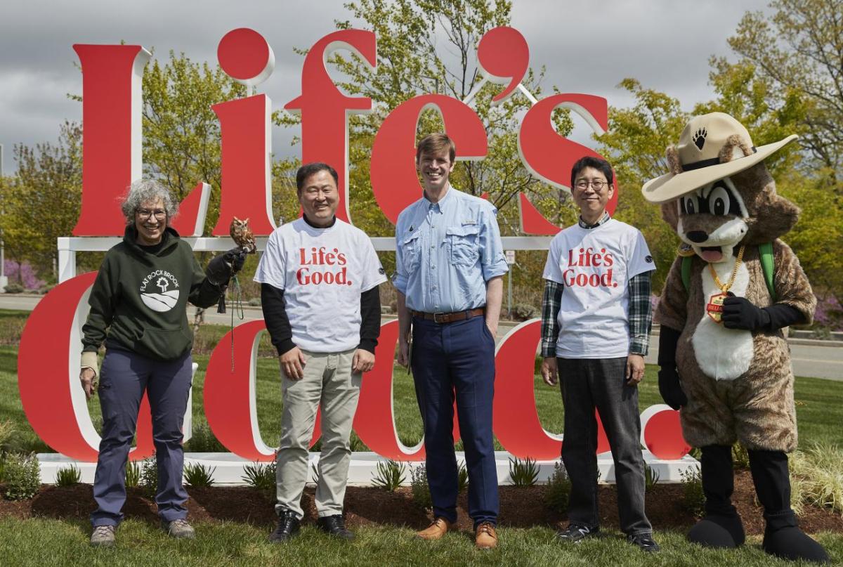 Group photo in front of "Life's Good" sign