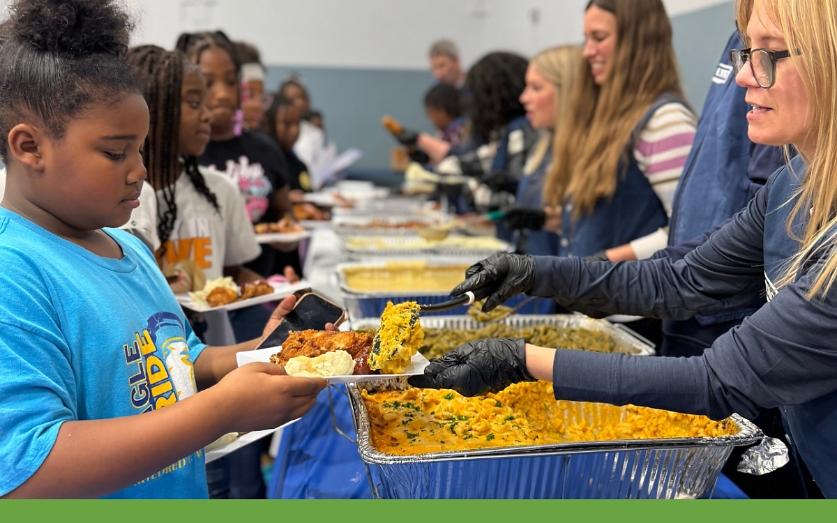 Children picking up plates of food at Day Of Dependability Dinner 