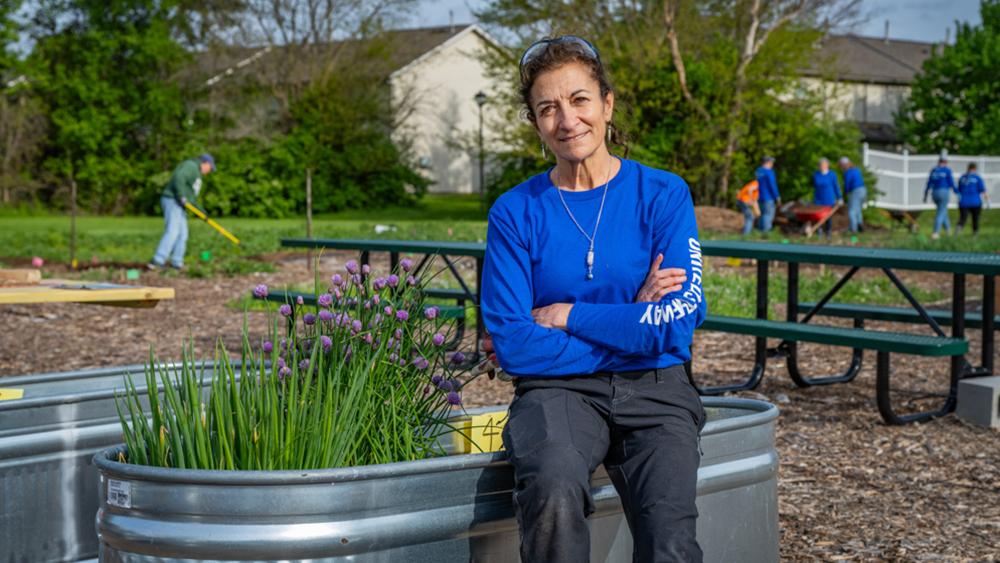 person standing in front of a planter