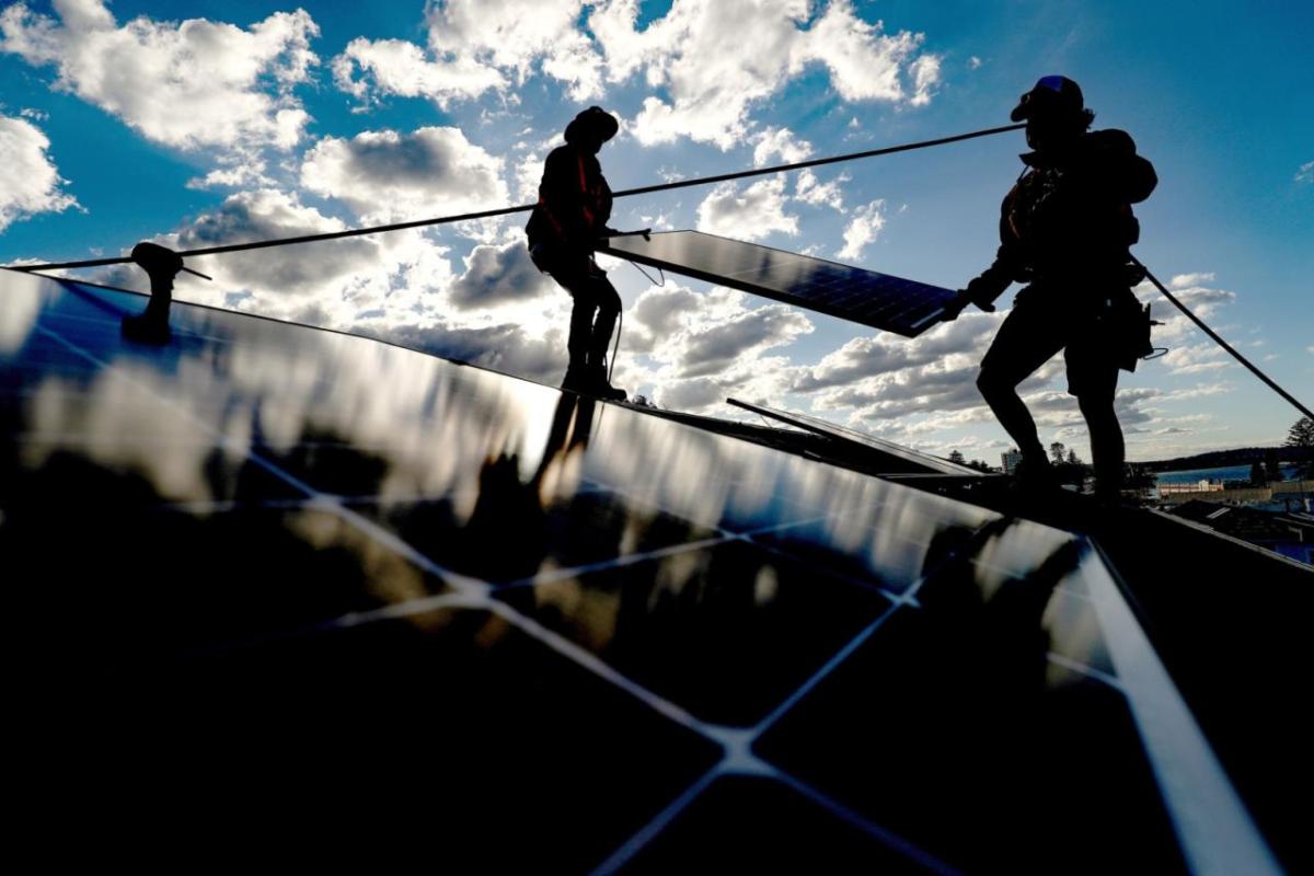 People installing solar panels