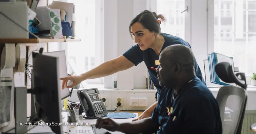 Health care workers consult their notes in a clinic. Photo by: The Bristol Myers Squibb Foundation
