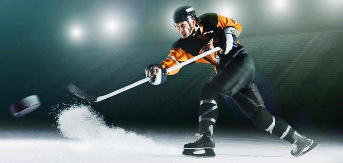 Hockey player hitting the puck
