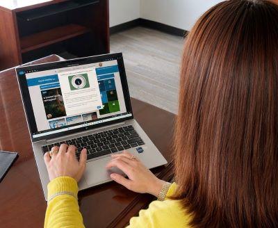 Person seated at a laptop.