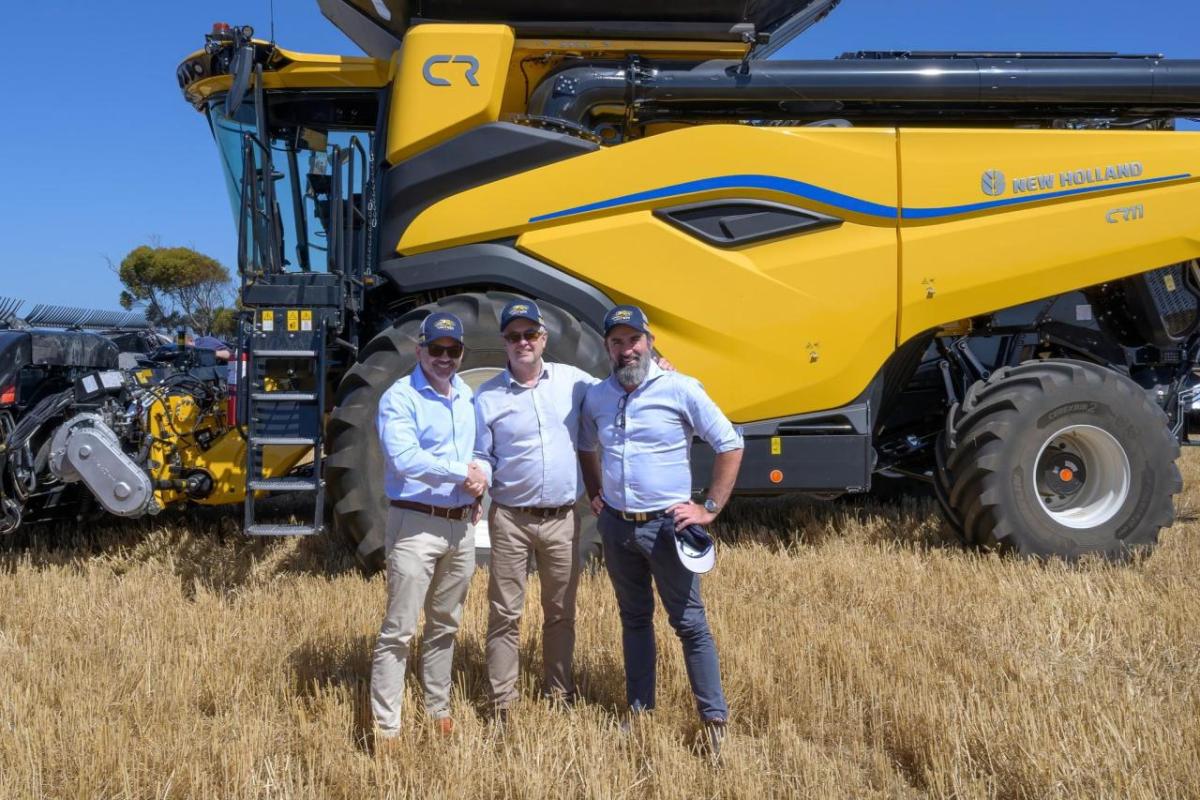 3 people in front of a tractor