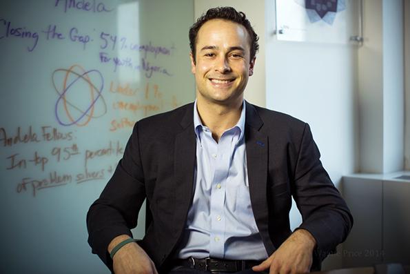 Man in dress shirt and blazer smiling