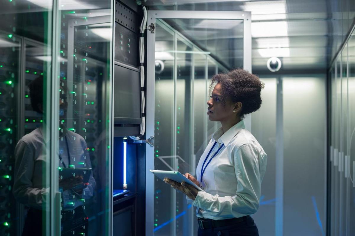 Data center worker observing servers