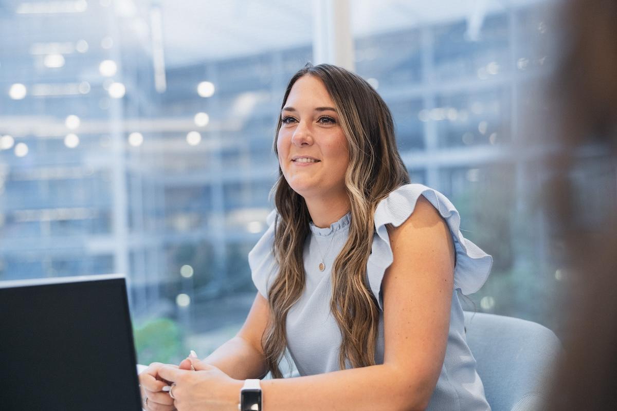 Principal employee seated in front of a laptop.