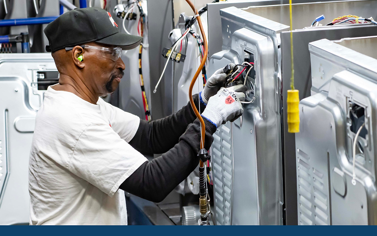 Worker assembling washing machine