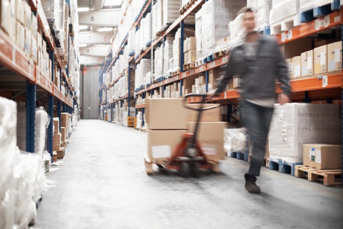 Worker pulling boxes in a warehouse