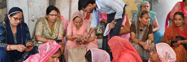 Group of Indian women looking at their phones