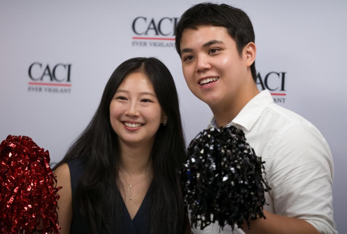 Two people at CACI's National Intern Day celebration