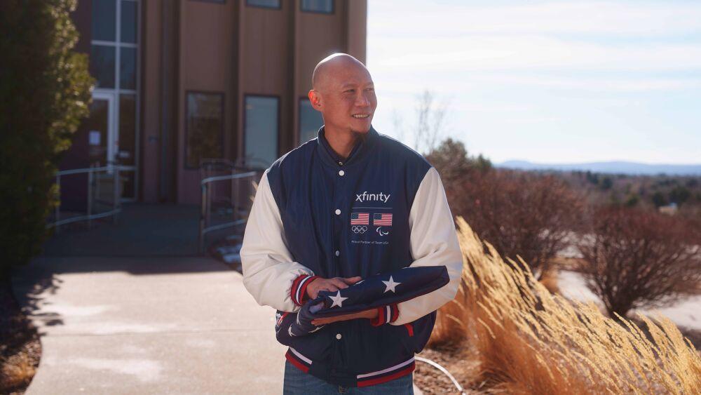U.S. Paralympic Gold Medalist Jen Lee holding folded up American flag