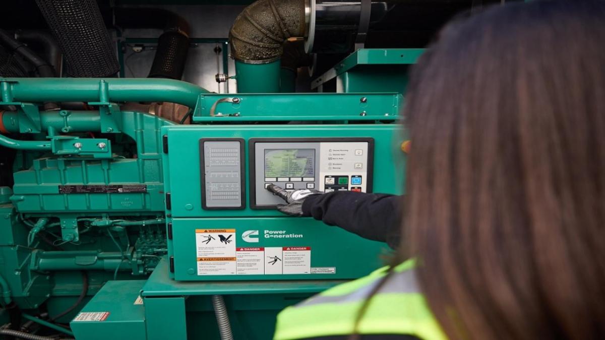 Worker looking at power generation equipment