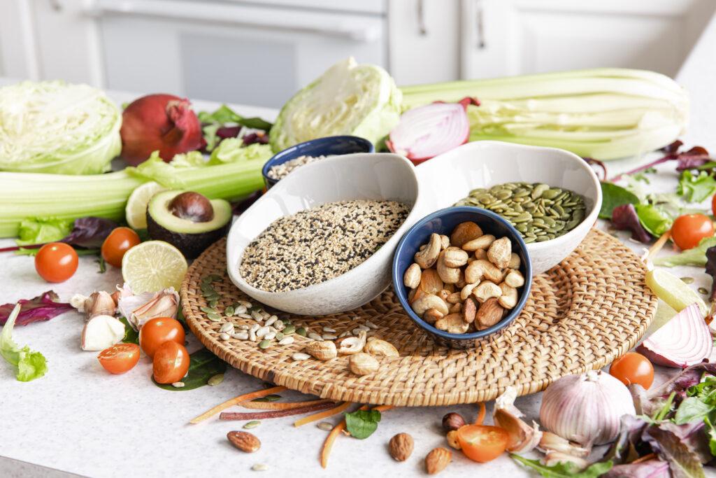 Closeup bowl chia seeds and other healthy foods on a kitchen table.