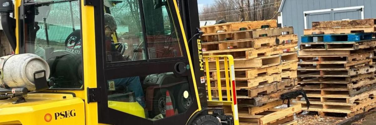 Forklift moving wooden pallets
