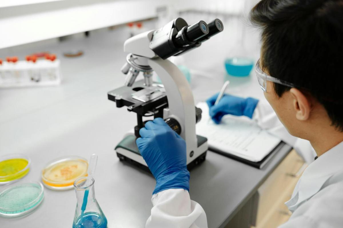 Scientist using microscope in laboratory