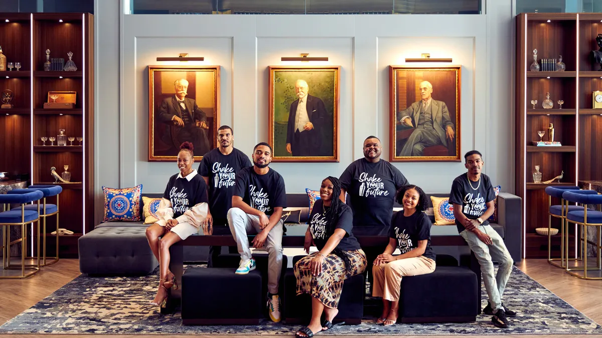 Group photo of 7 people wearing "Shake Your Future" shirts
