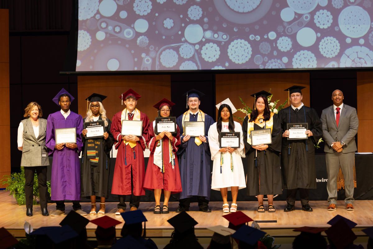 12 for Life students at graduation holding certificates