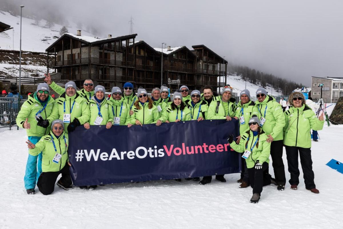 Group of Otis volunteers holding a We Are Otis banner.