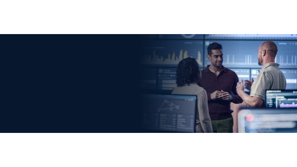 Three employees speaking together