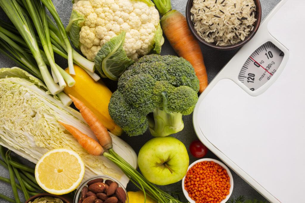 Vegetables and fruits shown near a scale.