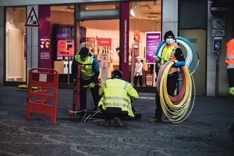 employees on street with cables